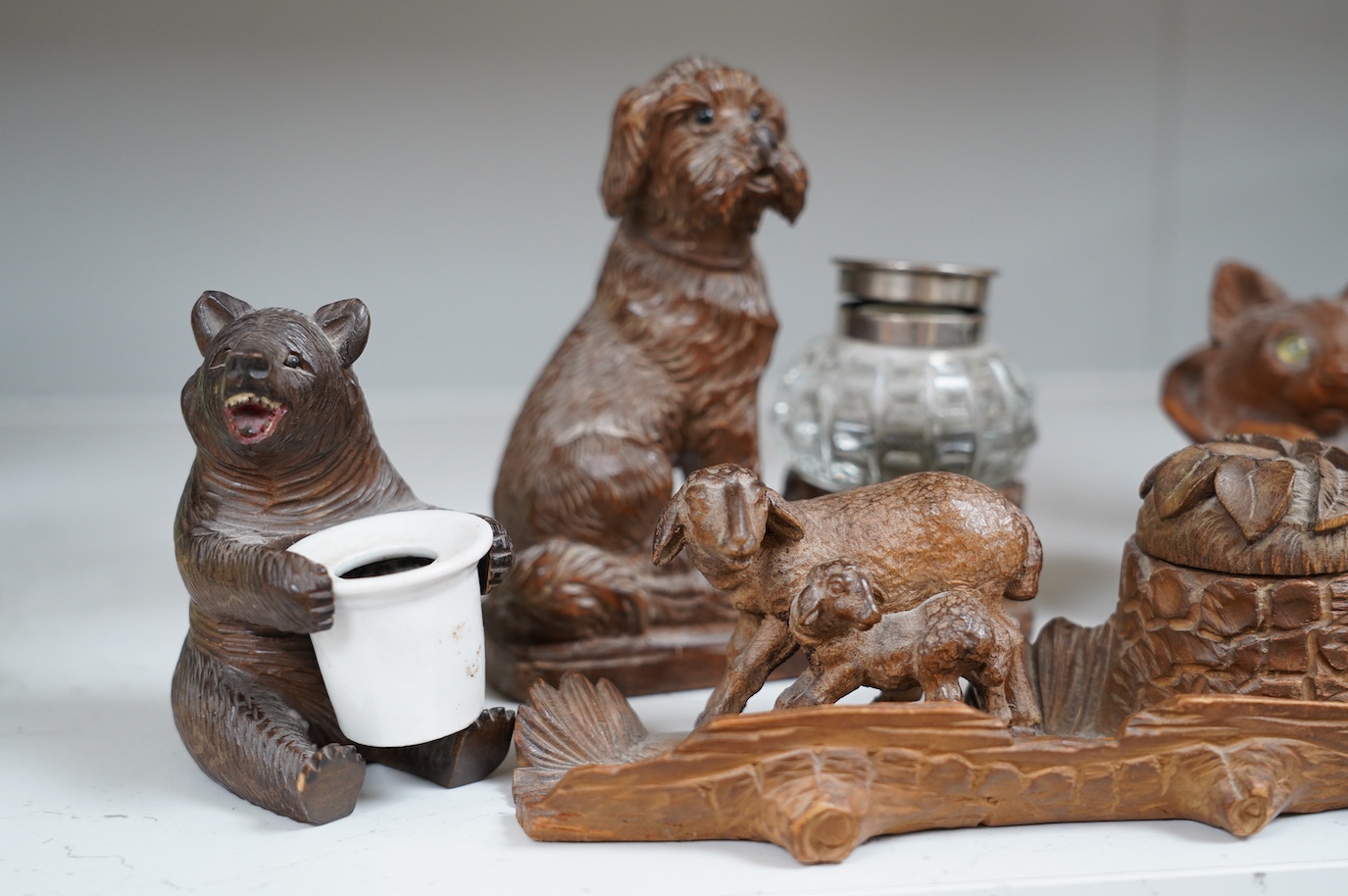 A collection of five carved wooden novelty animal inkwells, four black forest, tallest dog inkwell 15cm high. Condition - some small chips but fair